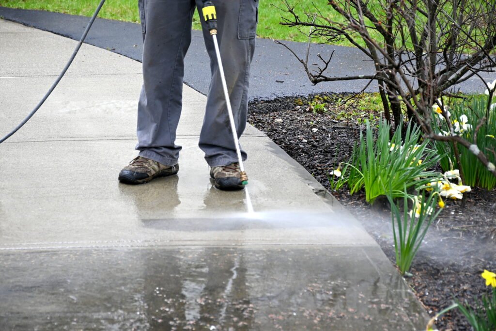 man-pressure-washing-house-driveway-in-miami